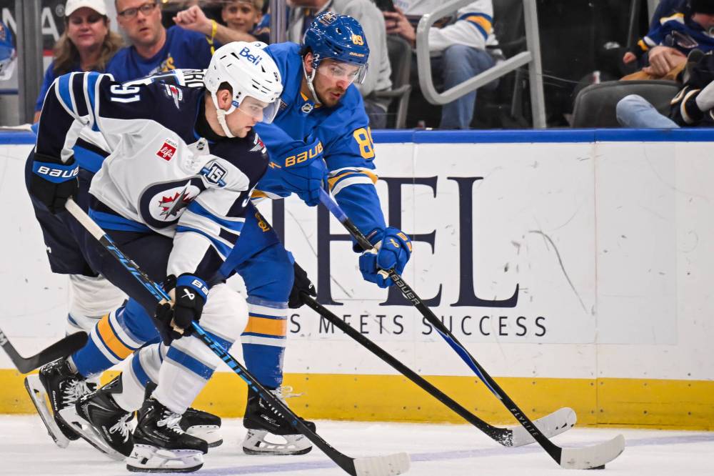 Connor Hamilton / The Associated Press
Winnipeg Jets’ Cole Perfetti, left, skates against St. Louis Blues’ Pavel Buchnevich, right, during the third period.
