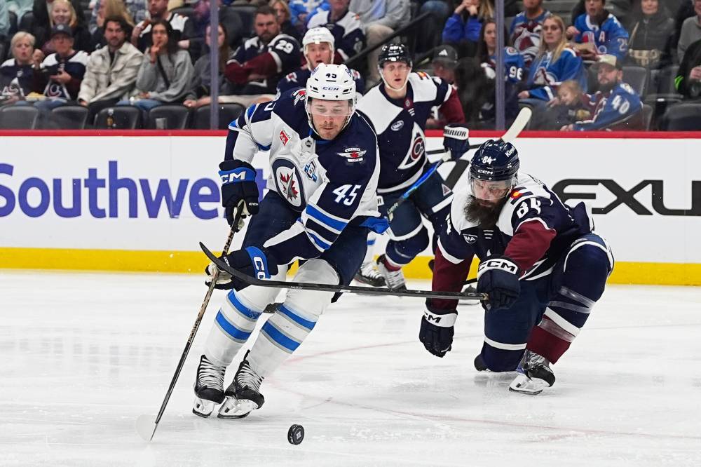 DAVID ZALUBOWSKI / THE ASSOCIATED PRESS
Winnipeg Jets left wing Cole Koepke (45) drives past Colorado Avalanche defenseman Brent Burns, right, to score in the second period on March 28. Koepke signed a two-year deal with the Jets that was announced on Saturday.