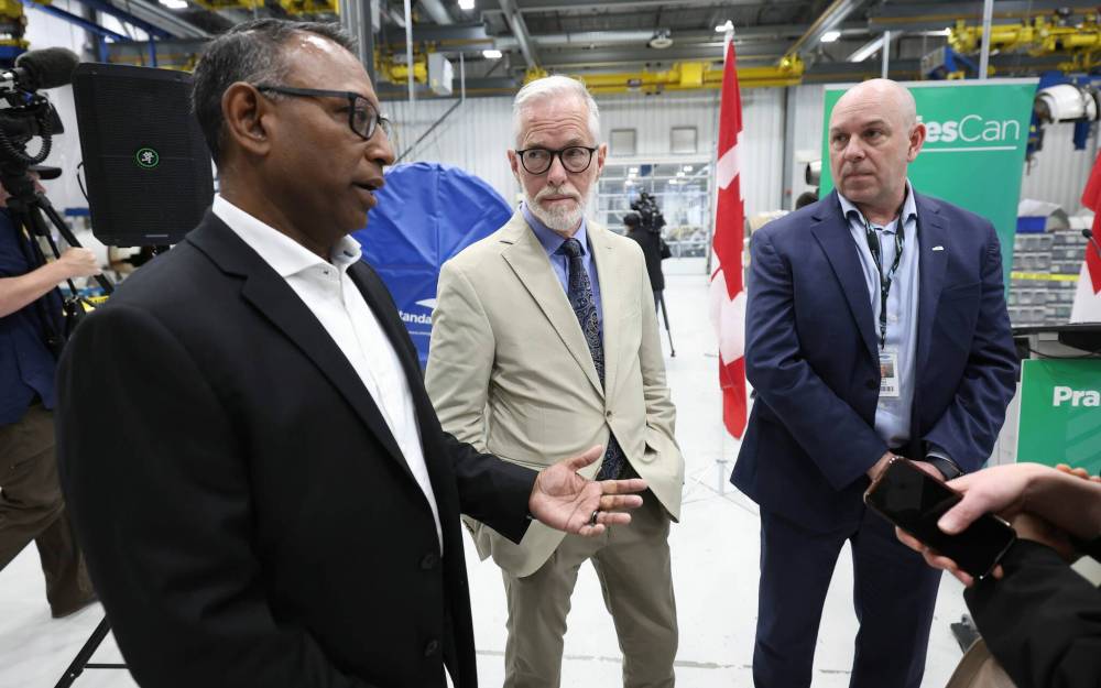 Ruth Bonneville / Free Press
Ron Drepaul, GM of Magellan Aerospace (from left); Rob Ranson, founder and president of Win-Shield Devices; and Chad Flowers, vice-president and general manager of StandardAero, talk Friday after Northern and Arctic Affairs Minister Rebecca Chartrand announcement.