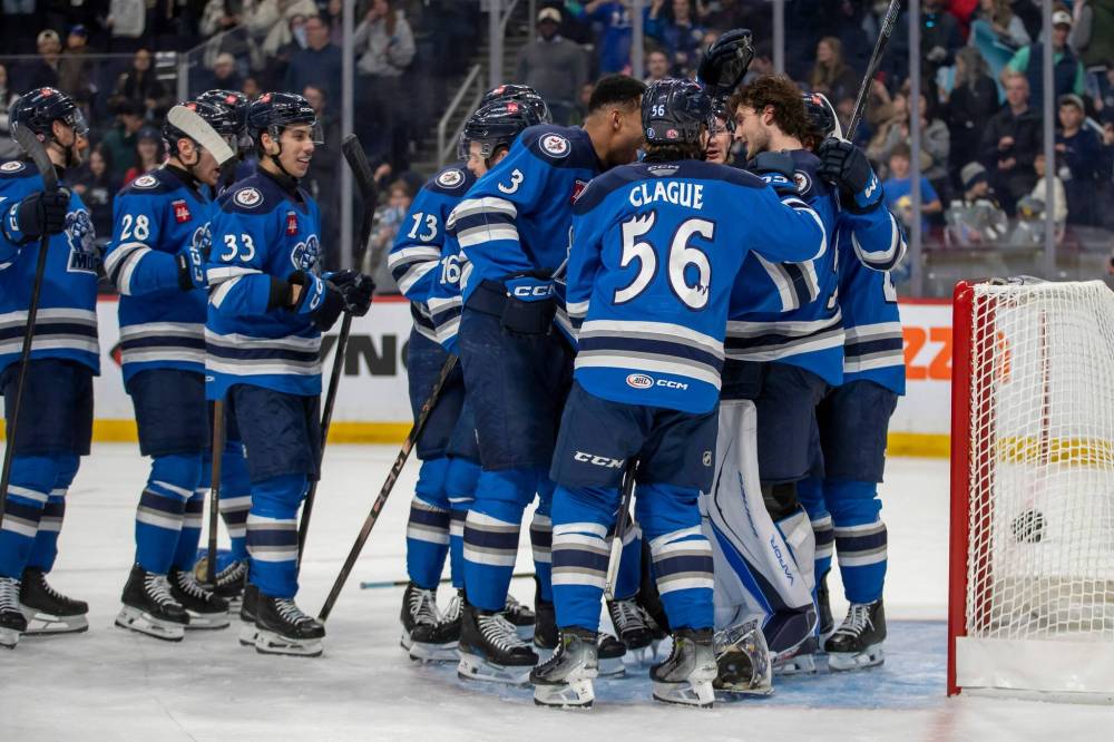 BROOK JONES / FREE PRESS
Manitoba Moose players congratulate goaltender Domenic Divincentiis (No. 50) on the team’s 2-1 victory over the Milwaukee Admirals on Friday.