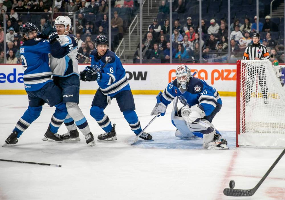 BROOK JONES / FREE PRESS
Manitoba Moose goaltender Domenic DiVincentiis (No. 50) and Moose teammate Ashton Sautner (No. 6) keep an eye on the puck while Moose defenceman Tyrel Bauer (No. 2) and Admirals left-winger Reid Schaefer (No. 49) battle in the slot during first period action.