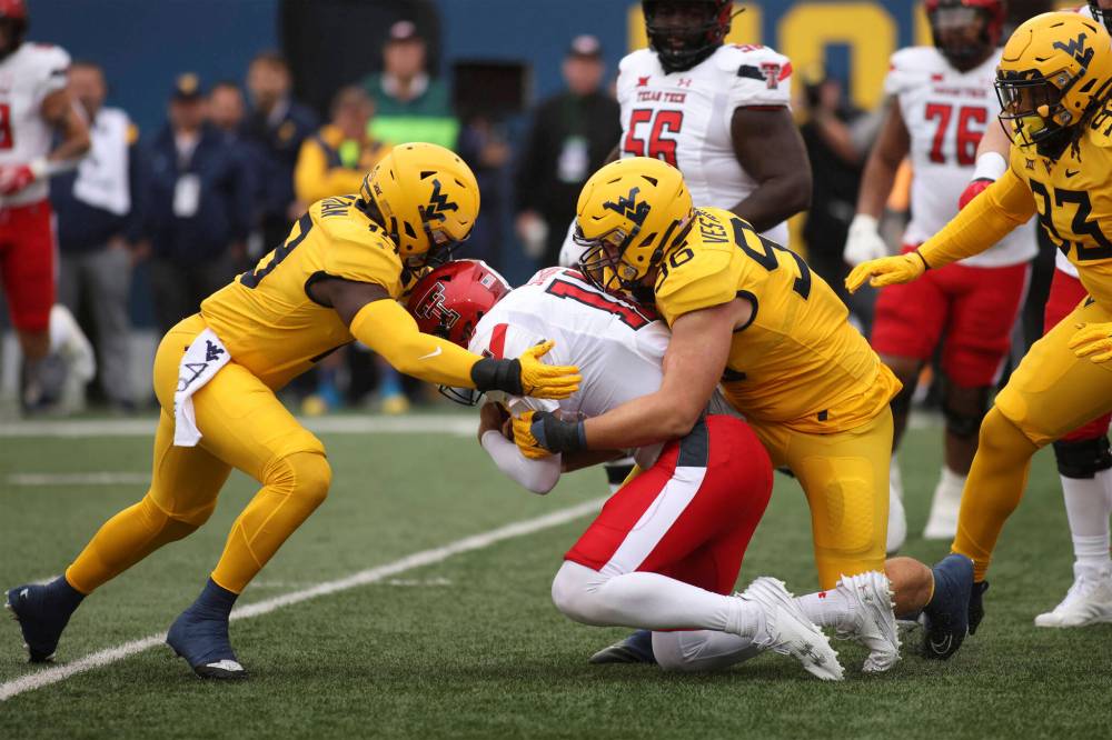 Chris Jackson / The Associated Press files
West Virginia defensive lineman Edward Vesterinen (right) sacks Texas Tech quarterback Tyler Shough during a 2023 game. The Bombers selected the Helsinki native fourth overall in the global draft.
