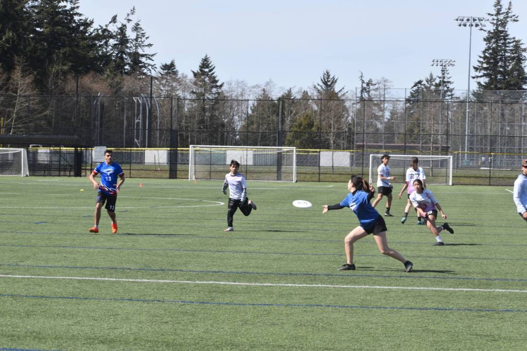 Semiahmoo Secondary students (in blue) play Kwantlen Park Secondary at a previous Myles Winch Ultimate Frisbee Tournament in South Surrey, held in honour of longtime teacher and coach Myles Winch, who died in 2016. The event is set for Wednesday, April 8 this year in South Surrey. (Tricia Leslie photo)
