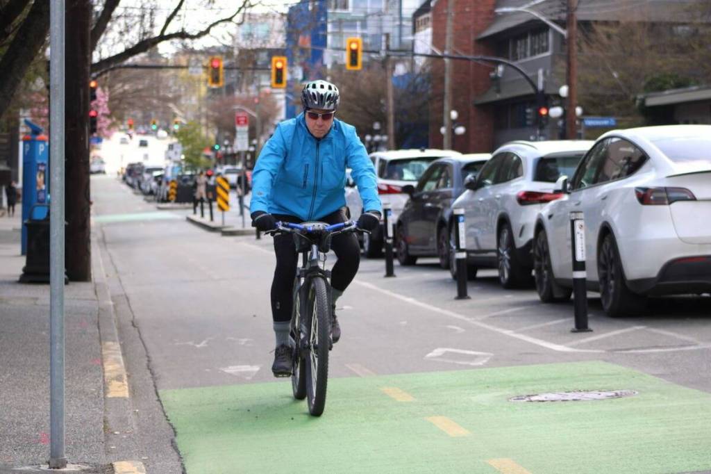 A cyclist rides down protected bike lanes in Victoria. (Black Press Media file photo)