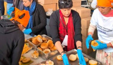 Raj Arneja (middle) and others prepare veggie burgers at the Nanak Foods stall during the 2025 Surrey Vaisakhi Parade in Newton. (Contibuted to Surrey Now-Leader)