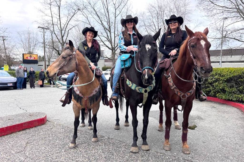Horse riders Kristyn Ward, left, Heather Kennedy, middle, and Simone Stich outside The Barn country bar in Surrey on Thursday, April 2, 2026. (Tom Zillich/Surrey Now-Leader)