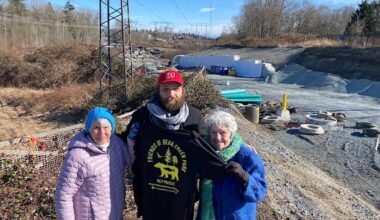 Friends of Bear Creek Park group members, from left, Evelyn Zaklan, Sebastian Sajda and Annie Kaps on a hill overlooking the 84 Avenue extension project in Surrey on Feb. 23, 2023. (Photo: Tom Zillich)