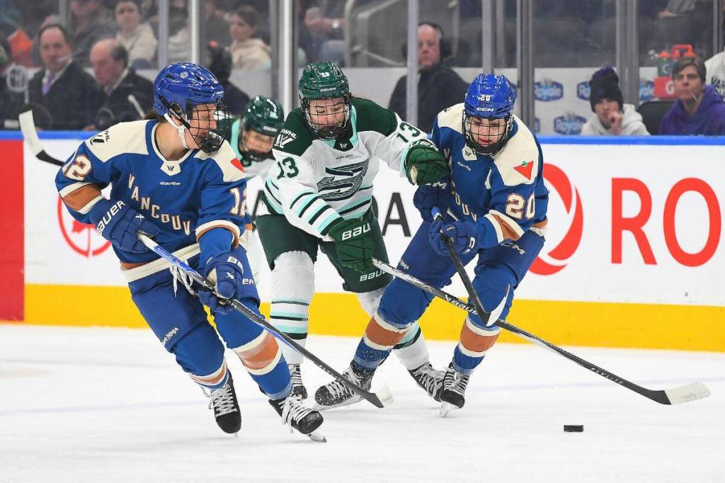 Goldeneyes Jenn Gardiner and Sarah Nurse battle Liz Schepers for the puck during Tuesday&rsquo;s (April 7) game at Rogers Arena in Edmonton. (PWHL)