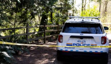 An RCMP vehicle is seen behind police tape at Walnut Park, where an incident has attracted a heavy police presence on Wednesday, April 8. (Anna Burns/Surrey Now-Leader)