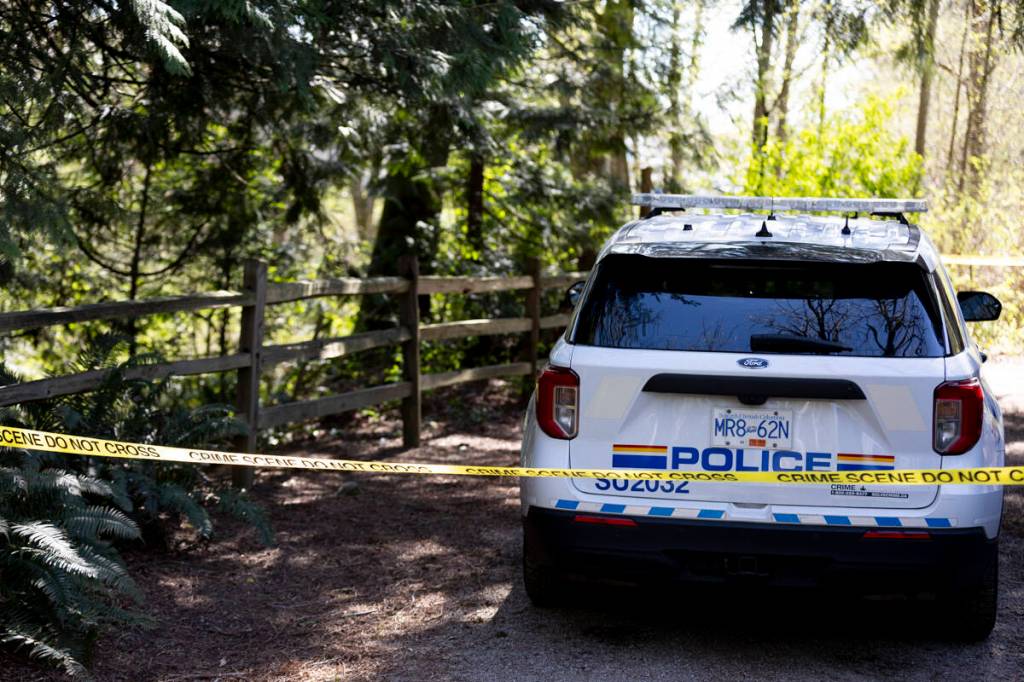 An RCMP vehicle is seen behind police tape at Walnut Park, where an incident has attracted a heavy police presence on Wednesday, April 8. (Anna Burns/Surrey Now-Leader)