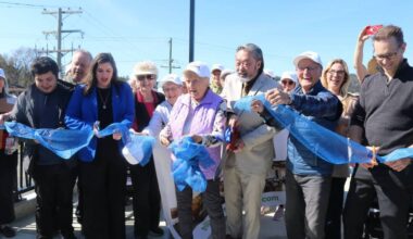 Songhees Coun. Eugene Sam, Esquimalt-Colwood MLA Darlene Rochford, and Mayor Doug Kobayashi cut the ribbon with the help of West Shore Village seniors at the official opening of the Galloping Goose pedestrian and cycling bridge. (Ben Fenlon/Goldstream Gazette)