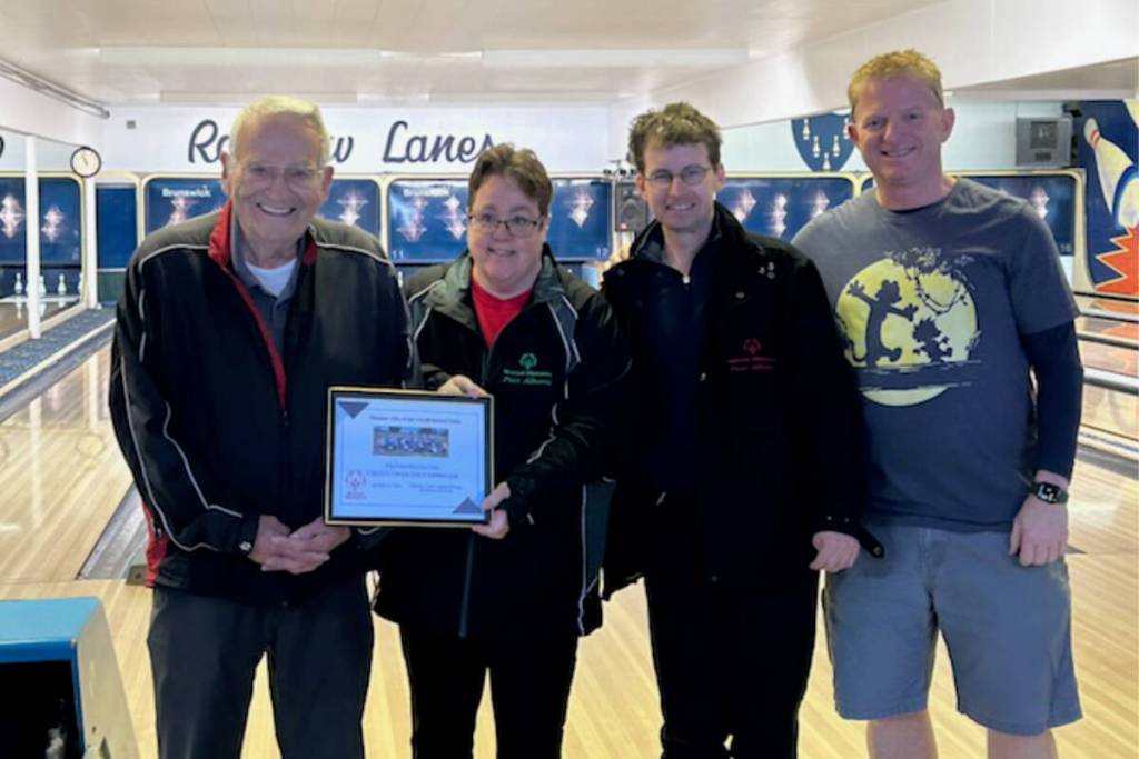 Special Olympics athletes Simone Myers, second from left, and Michael Booth, third from left, present a plaque to Alberni Men&rsquo;s Golf committee members Gerry Fagan, left, and Ted Stewart, right, at Rainbow Lanes. The Men&rsquo;s Golf Club donated $1,500 to Special Olympics last year. (Submitted photo/ Alberni Valley News)