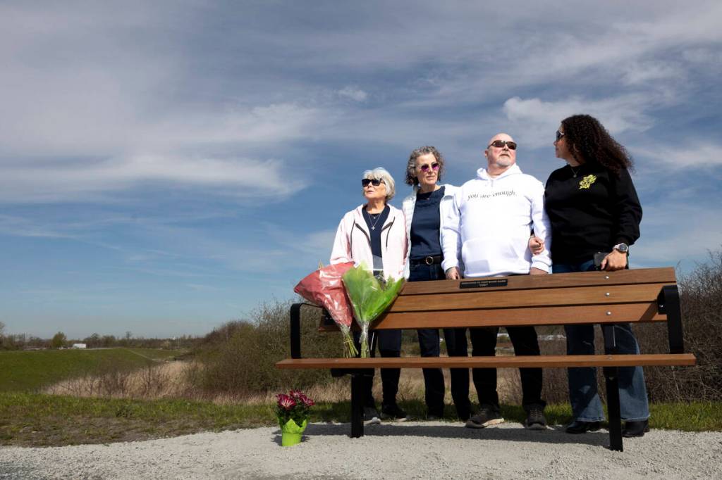 Aron&rsquo;s mum, left, his sister Shelley Dunn, Aron and his niece Brandi Basra pose for a photo in front of Tori&rsquo;s bench at Mud Bay Park on Friday, April 10, 2026, in Surrey for the installation of her memorial bench. (Anna Burns/ Surrey Now-Leader)