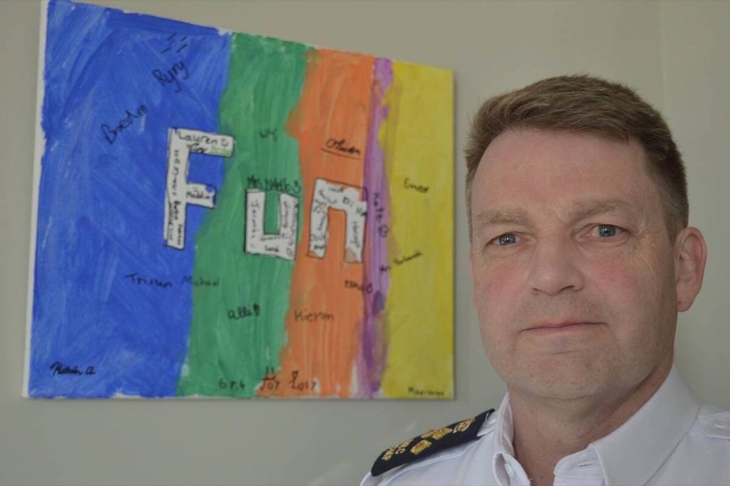 Brian Edwards pictured when he was Surrey RCMP&rsquo;s officer in charge and assistant commissioner, with a painting his son did in Grade 4 that he hung in a place of honour on his office wall. (Tom Zytaruk/Surrey Now-Leader file)