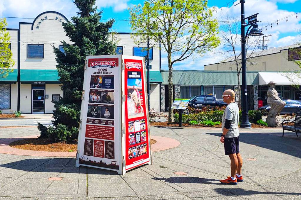 A man checks out a new sign in Hawthorne Square in Cloverdale advertising the upcoming 78th Cloverdale Rodeo and 135th Country Fair. (Photo: Malin Jordan/Cloverdale Reporter)