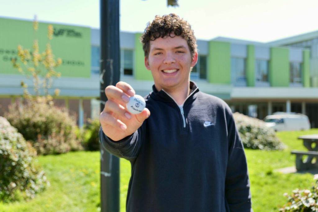 Luke Bernakevitch, 15, holds the golf ball – TaylorMade TP5X – from his historic par-4 albatross at Olympic View Golf Club on April 23. The Oak Bay High student beat roughly six million to one odds to make the ace. (Tony Trozzo/Oak Bay News)