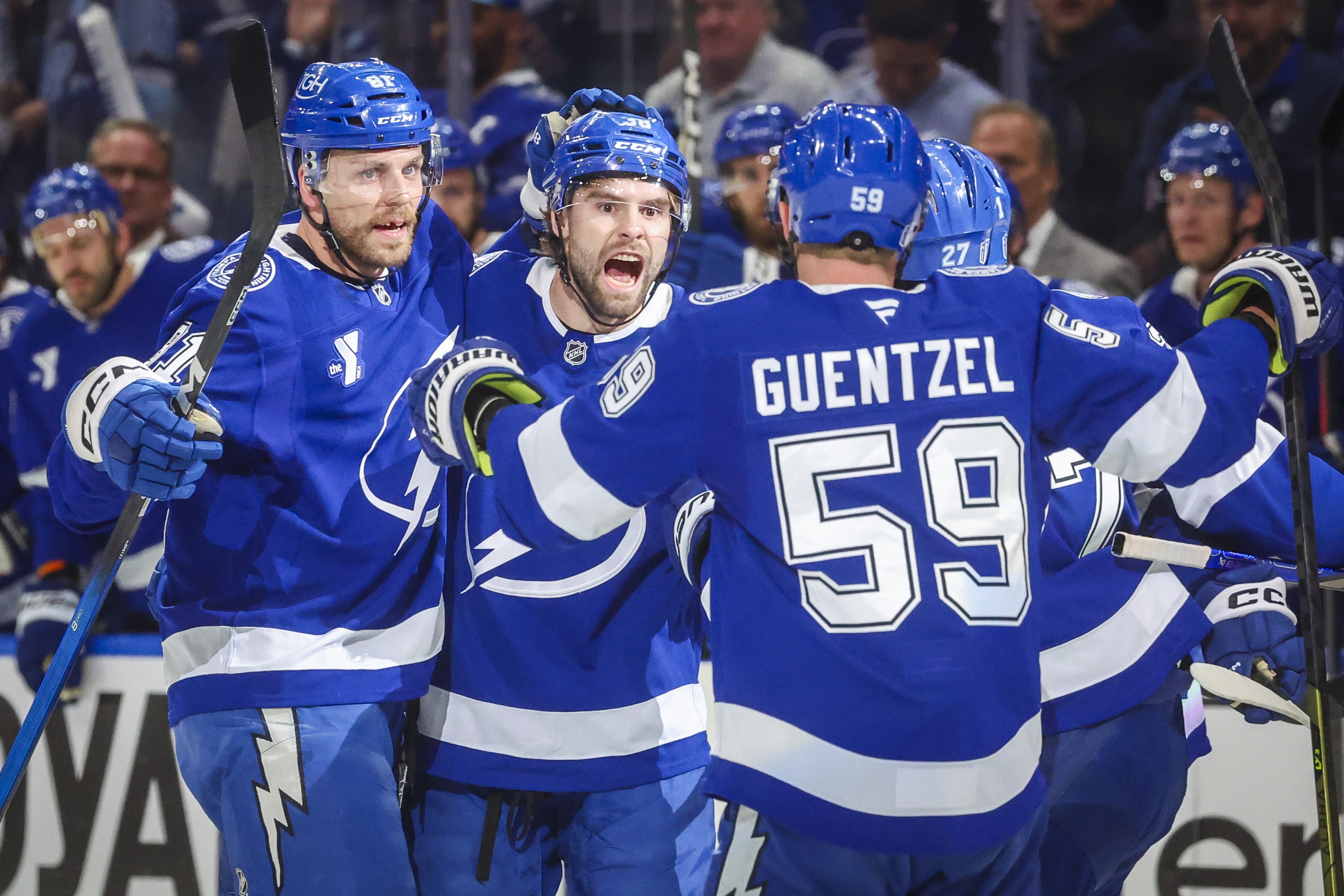 Lightning players embrace each other in celebration.