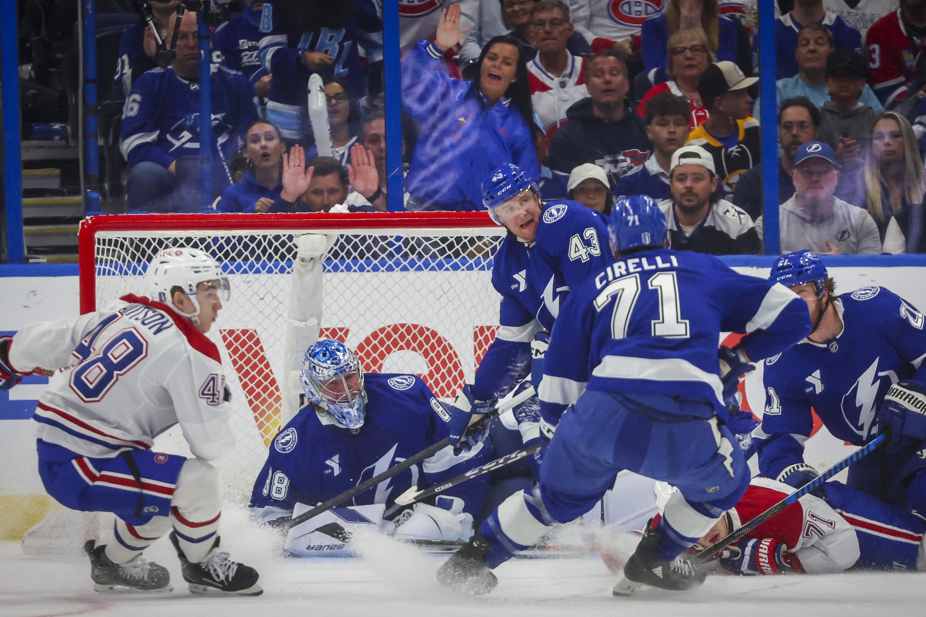 Tampa Bay Lightning goaltender Andrei Vasilevskiy falls to the ice as players scramble for the puck