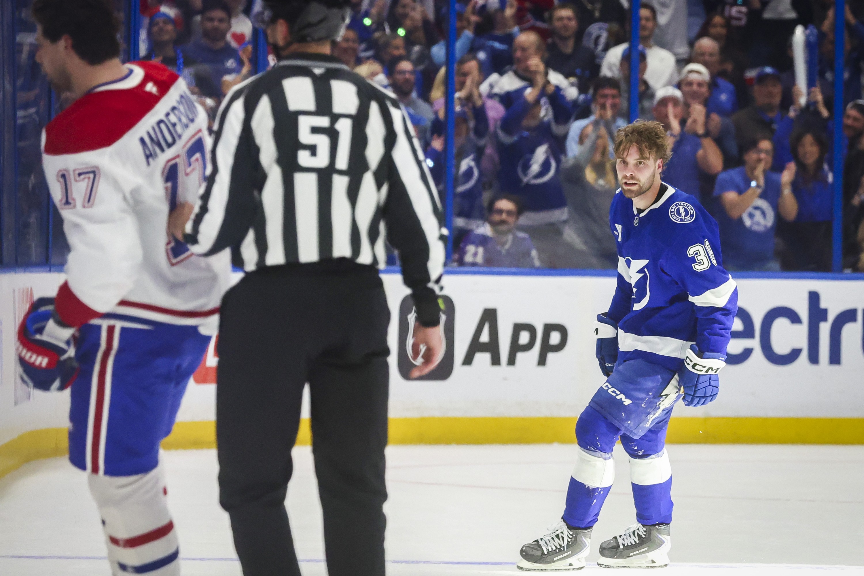 Tampa Bay Lightning's Brandon Hagel looks at Canadiens right wing Josh Anderson (17) while Anderson is being led to the penalty box