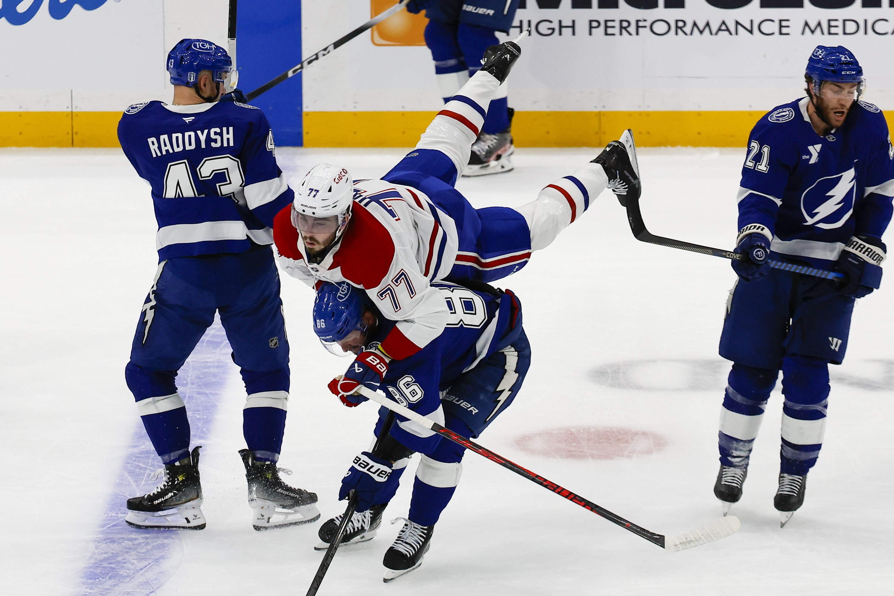 Canadiens centre Kirby Dach flies off the back of Tampa Bay Lightning right wing Nikita Kucherov