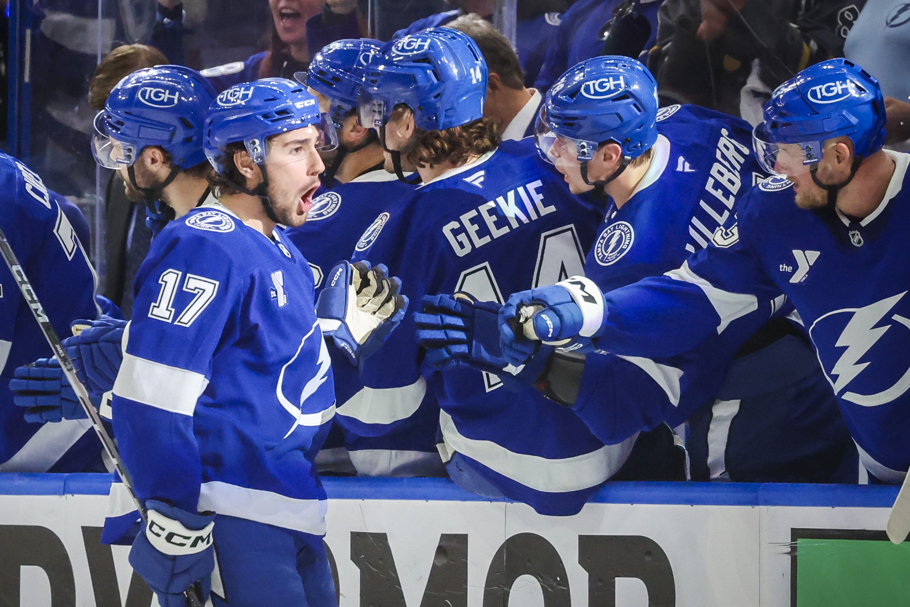 Tampa Bay Lightning centre Dominic James pumps gloves with teammates as he skates by the Tampa bench