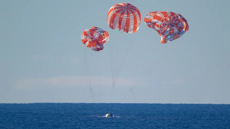 Handout photo provided by NASA shows NASA's Orion spacecraft with Artemis II crewmembers NASA astronauts Reid Wiseman, commander; Victor Glover, pilot; Christina Koch, mission specialist; and CSA (Canadian Space Agency) astronaut Jeremy Hansen, mission specialist aboard, as it lands in the Pacific Ocean off the coast of California, Friday, April 10, 2026