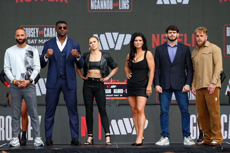 Rousey with opponent Gina Carano (centre-left) and (left to right) Nakisa Bidarian, Francis Ngannou, Philipe Lins and Jake Paul (Getty)