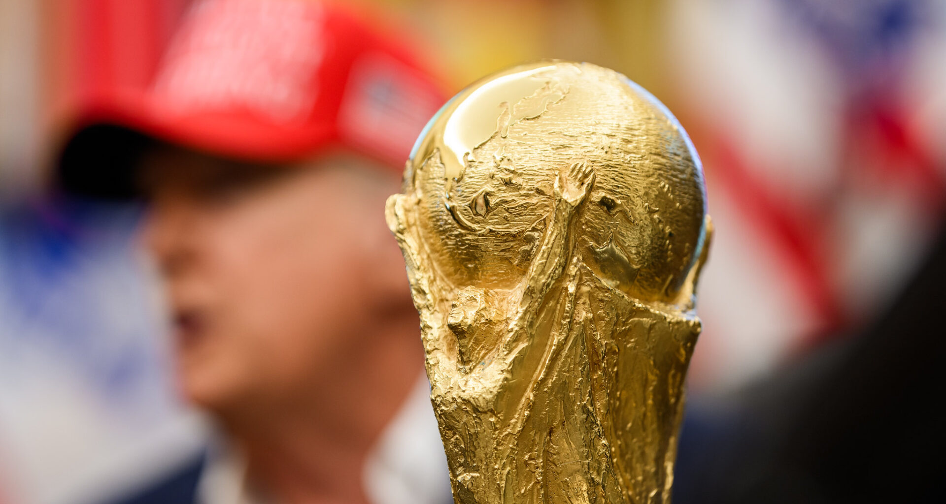 The soccer World Cup trophy sits in front of President Donald Trump