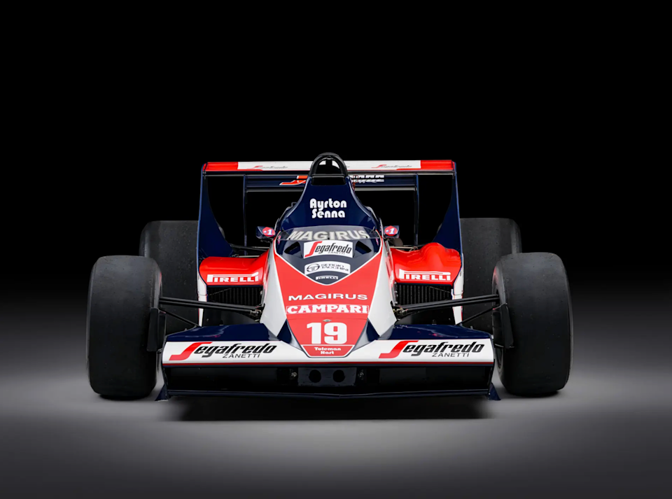 senna first formula 1 racing car with prominent sponsorships on black background