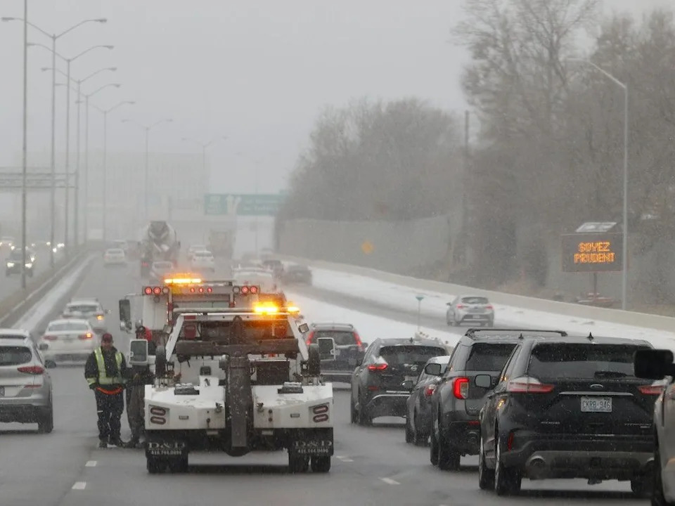  Two tow trucks stop to help someone on Highway 417 during a messy morning in a file photo.