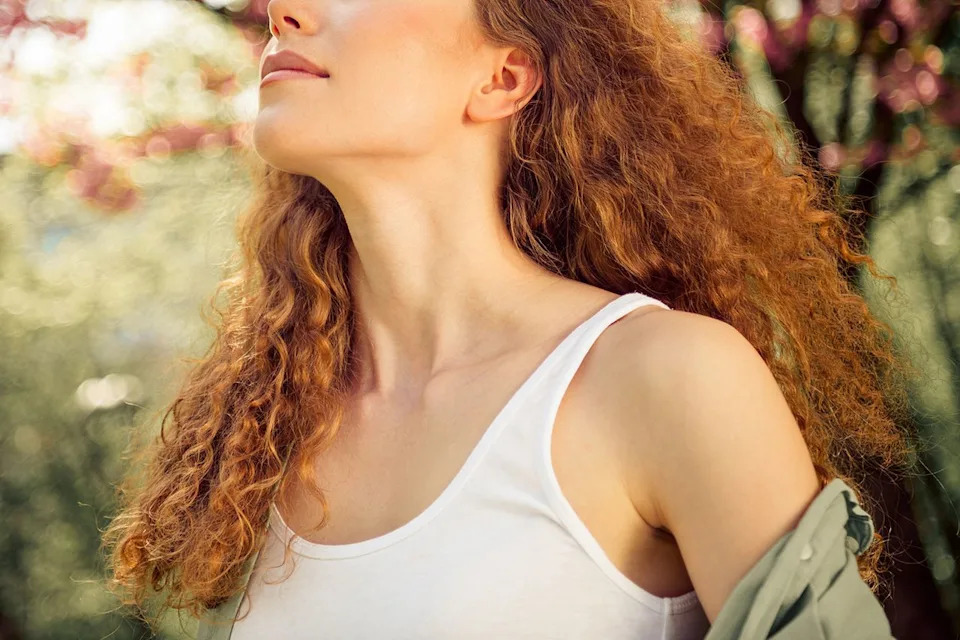Stock image of a redheaded woman in the sunCredit: Getty