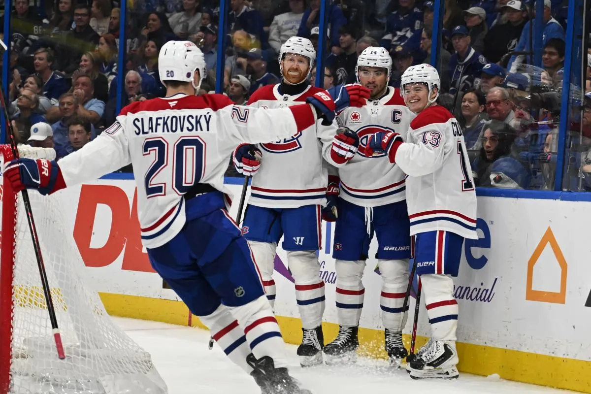 Montreal Canadian right wing Cole Caufield (13) celebrates with his teammates after scoring a goal in the second period against the Tampa Bay Lightning at Benchmark International Arena.