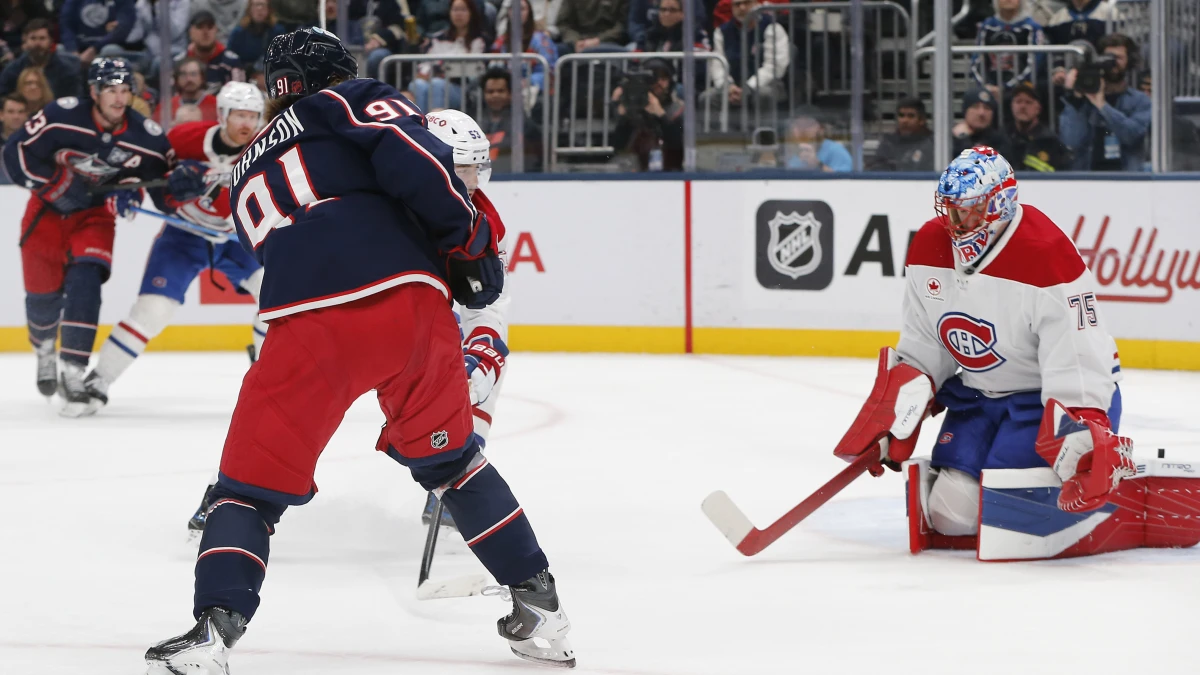 Montreal Canadiens goalie Jakub Dobes (75) makes a save on the shot attempt of Columbus Blue Jackets center Kent Johnson (91) during the second period at Nationwide Arena.