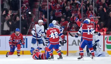 Montreal Canadiens forward Juraj Slafkovsky (20) celebrates with teammates including forward Cole Caufield (13) and forward Nick Suzuki (14) after scoring a goal against the Tampa Bay Lightning during the third period at the Bell Centre.