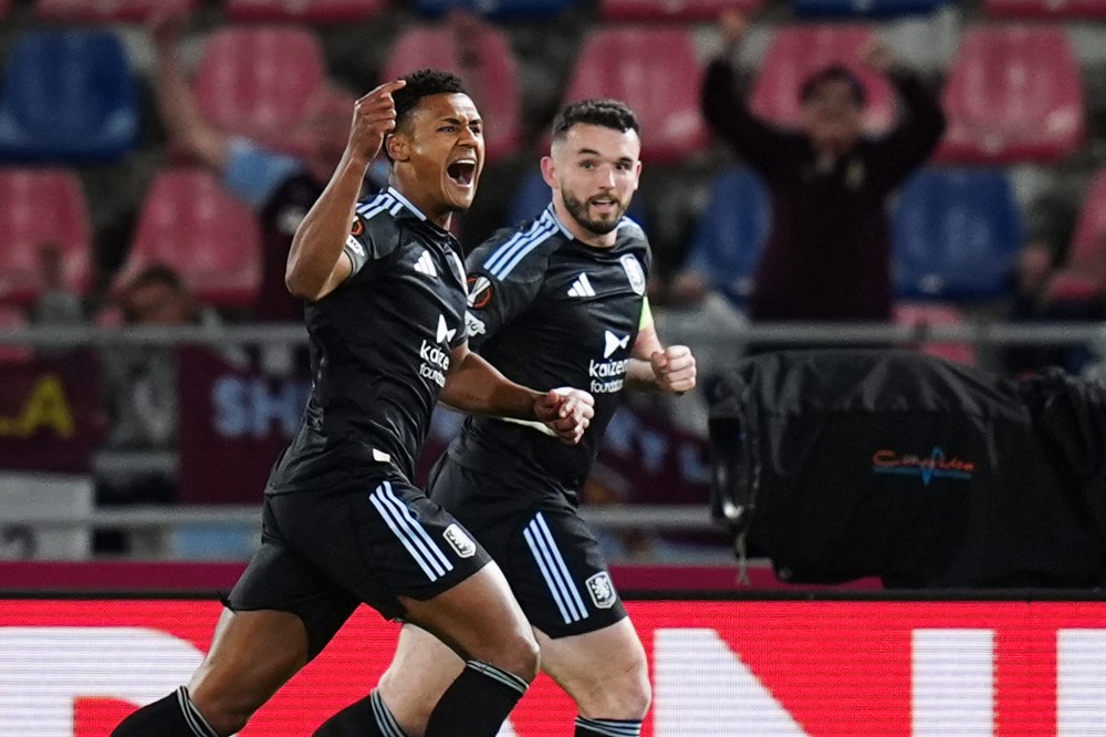 Aston Villa's Ollie Watkins, left, celebrates scoring during the Europa League soccer match between Bologna and Aston Villa in Bologna, Italy, Thursday April 9, 2026. (Massimo Paolone/LaPresse via AP)