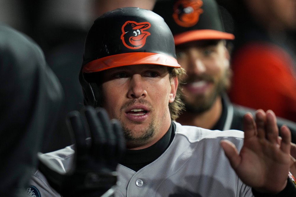 Baltimore Orioles' Adley Rutschman (35) celebrates after scoring on a single from Tyler O'Neill (9) during the fourth inning of a baseball game against the Chicago White Sox, Monday, April 6, 2026, in Chicago. (AP Photo/Erin Hooley)