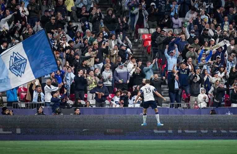 Vancouver Whitecaps' Thomas Muller celebrates his goal during the first half of an MLS soccer match against Sporting Kansas City, in Vancouver