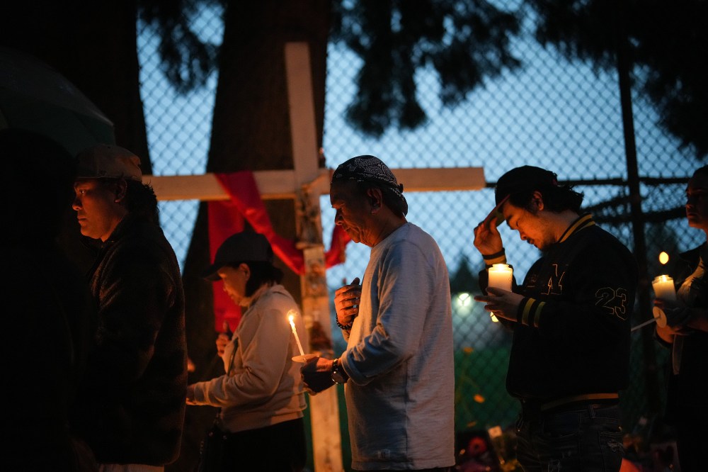 People gather for a candlelight march during a vigil on the street where a vehicle-ramming attack occurred at the Filipino community's Lapu Lapu Day festival last week, on a provincial day of mourning for the victims, in Vancouver, on Friday, May 2, 2025. THE CANADIAN PRESS/Darryl Dyck