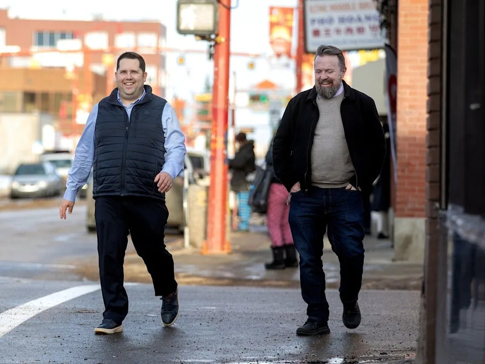 Edmonton city councillors Michael Janz, left, and Jon Morgan walk through Chinatown after attending the launch of the 2026 Chinatown Vibrancy Fund on Jan. 13.