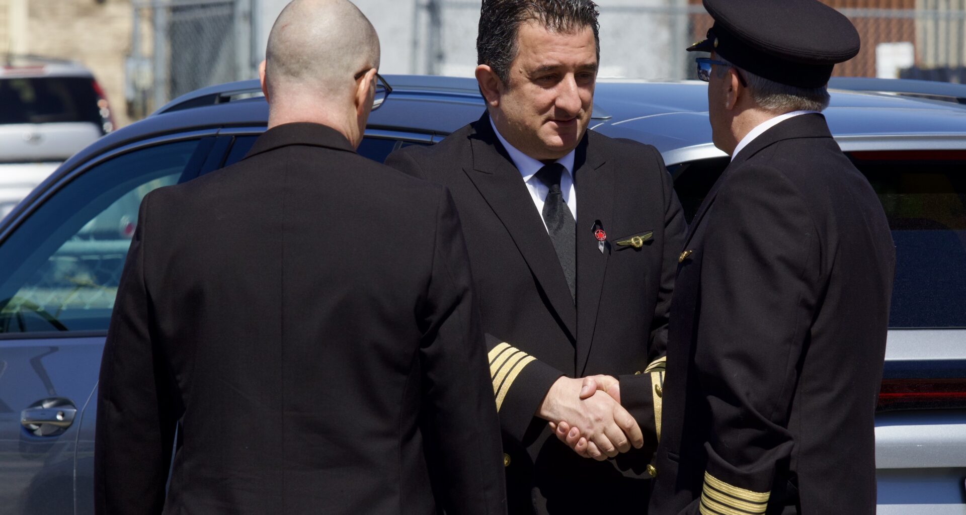 Uniformed pilots chat at a visitation for a pilot killed in a crash.