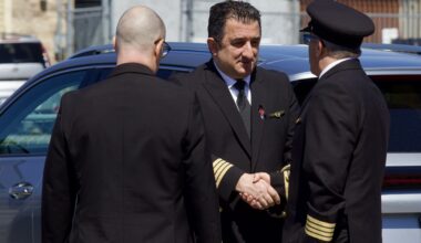 Uniformed pilots chat at a visitation for a pilot killed in a crash.