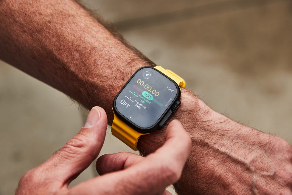 Smartwatch displaying timer and pace metrics on a wrist. Smartwatch displaying timer and pace metrics on a wrist.