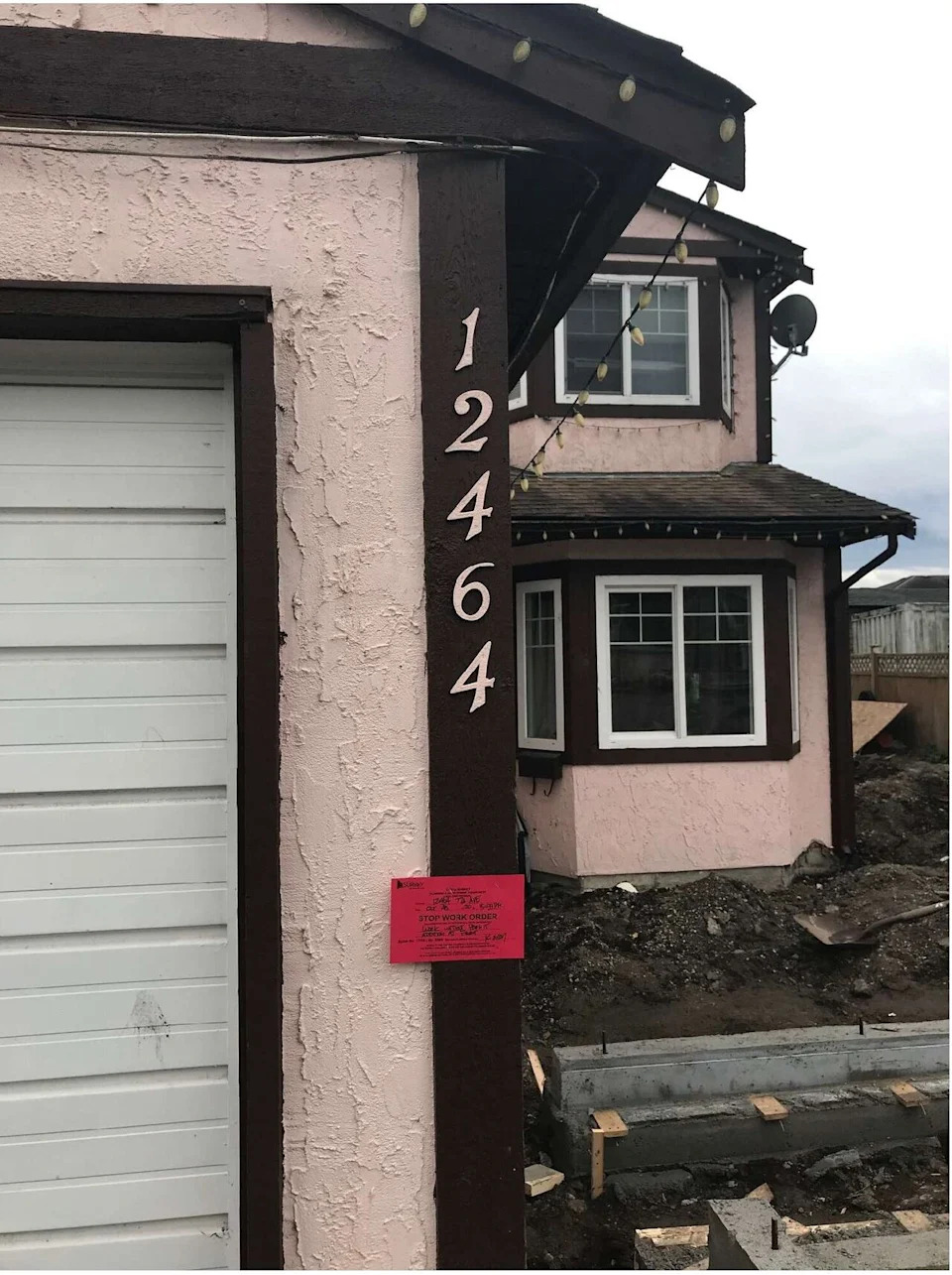 A homeowner in Surrey's Strawberry Hill area is seen making unpermitted additions despite a prominent stop work order.