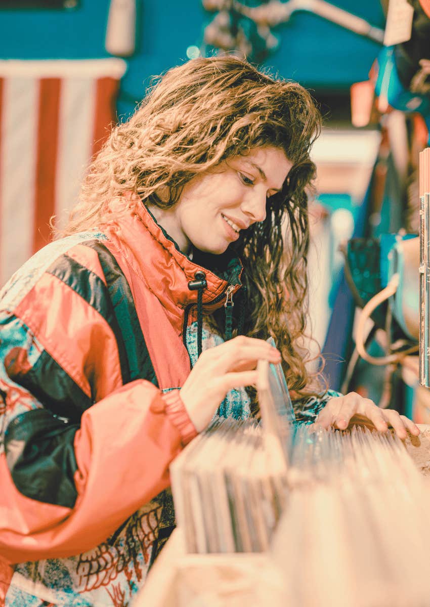 80s theme of young woman looking through records at store