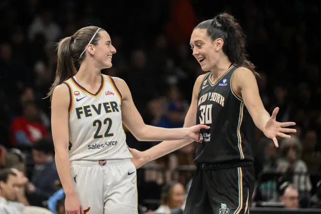 Apr 25, 2026; Brooklyn, NY, USA; Indiana Fever guard Caitlin Clark (22) and New York Liberty forward Breanna Stewart (30) interact during the first half at Barclays Center. Mandatory Credit: John Jones-Imagn Images