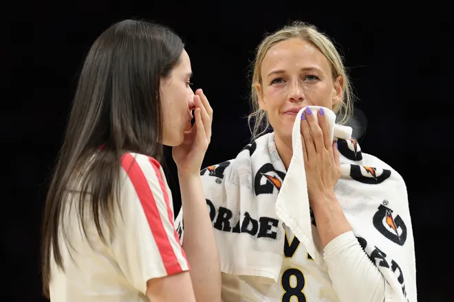 Sophie Cunningham #8 and Caitlin Clark of the Indiana Fever talk during the first half.