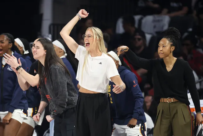 (L-R) Caitlin Clark, Sophie Cunningham, and Assistant Coach Briann January of the Indiana Fever cheer.