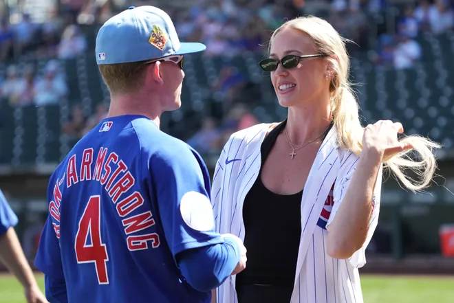 Chicago Cubs center fielder Pete Crow-Armstrong (4) talks to WNBA star Sophie Cunningham.