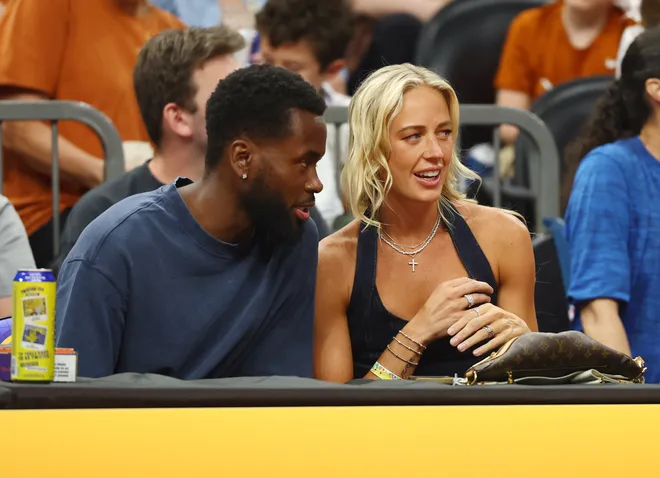 Sophie Cunningham sits courtside to watch the UCLA Bruins against the Texas Longhorns during a semifinal of the Final Four.