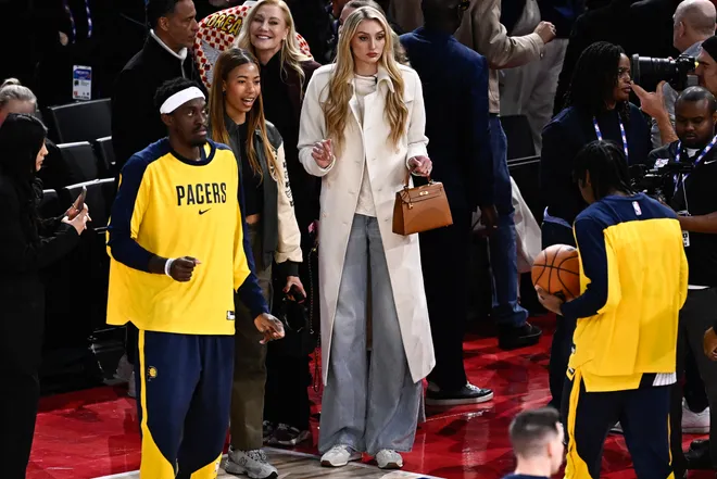 Cameron Brink (C) looks on, courtside at the NBA basketball game between the Indiana Pacers and the San Antonio Spurs.
